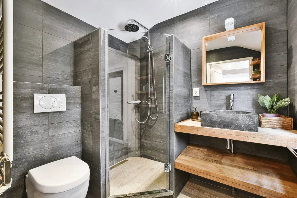 Awards in New Plymouth for modern bathroom renovations with tiled walls, wooden vanity, and glass shower by Bathroom Renovations New Plymouth