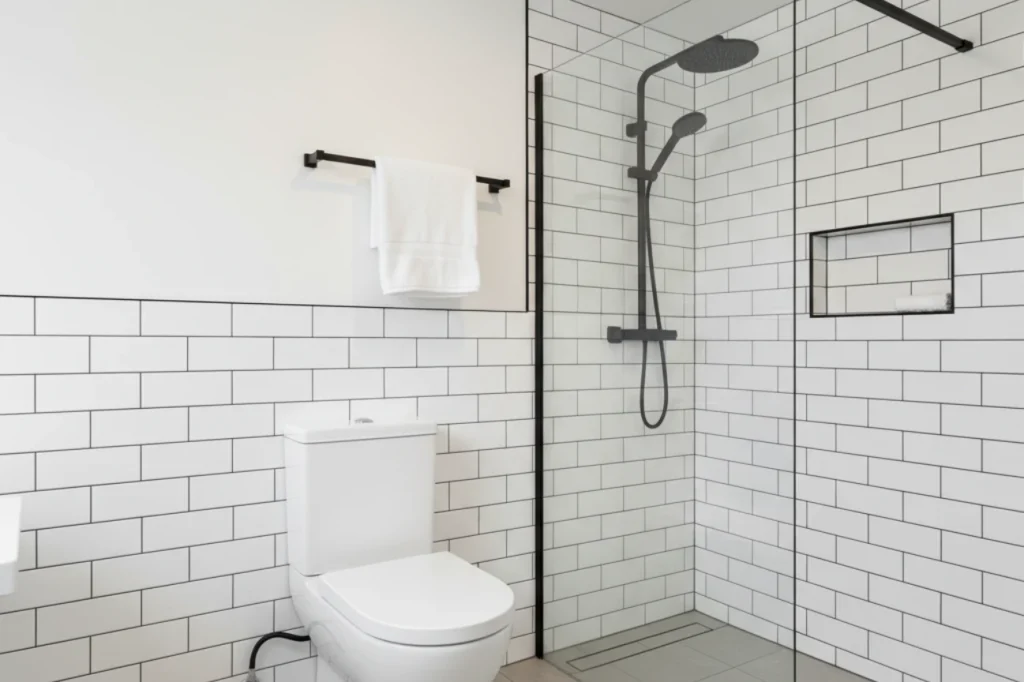 Budget bathrooms in New Plymouth with walk in shower, white subway tiles, and simple fixtures by Bathroom Renovations New Plymouth