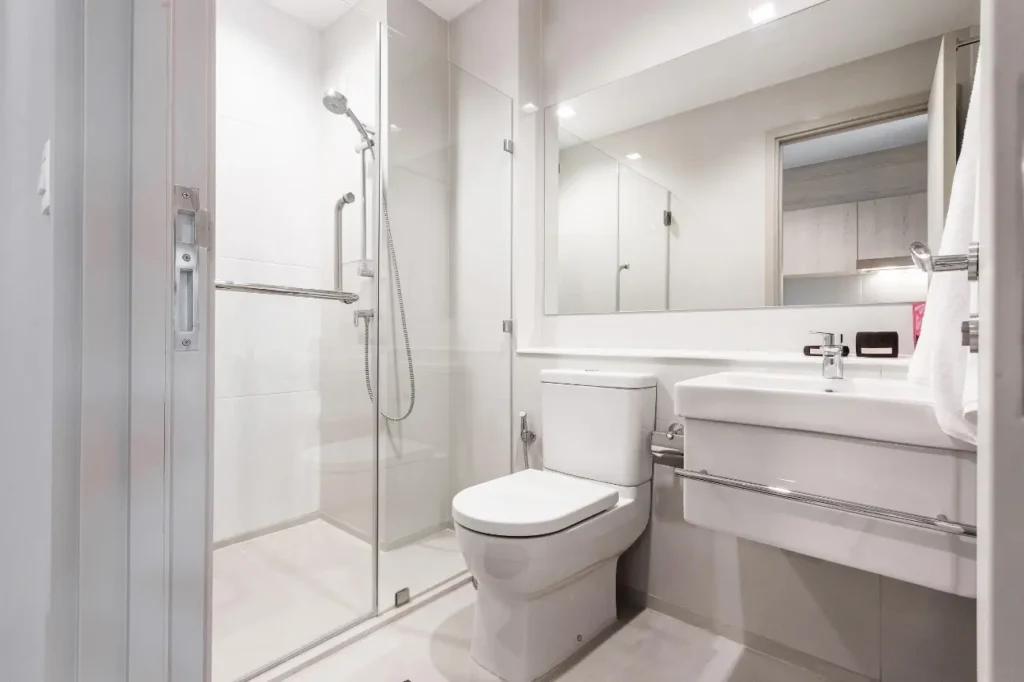 Bright small bathroom with glass shower designed to reflect lifestyle by Bathroom Renovations New Plymouth.