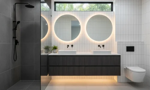 Contemporary bathrooms in New Plymouth with dual vanities, round mirrors, and sleek shower by Bathroom Renovations New Plymouth