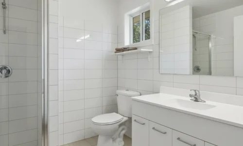 Budget bathrooms in New Plymouth with clean vanity, shower, and tiled walls by Bathroom Renovations New Plymouth